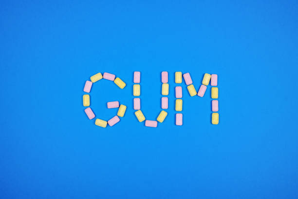 istock Word GUM written with chewing gum on blue background 879770552