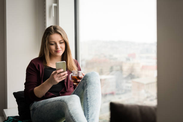 istock Girl watching streaming video on her smartphone 879770720