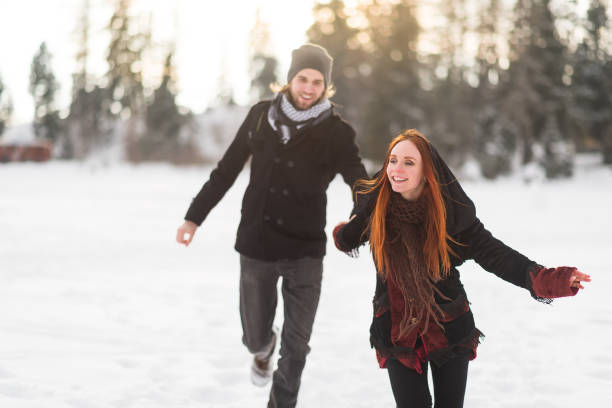 istock Redhead woman leading her man to explore mountains 879773250