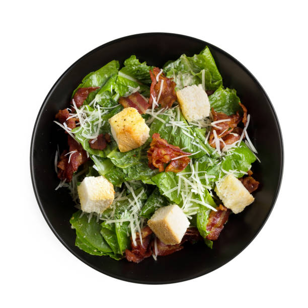 istock Caesar salad with crispy bacon fry and Fresh green cos lettuce isolated on white background 879774402