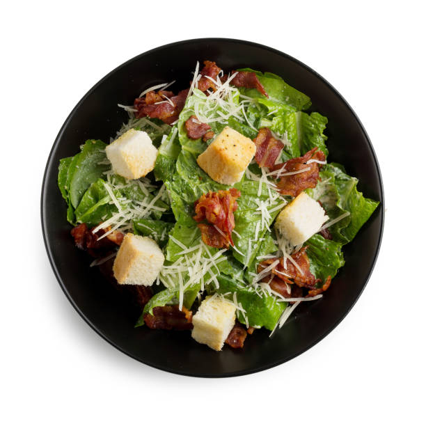 istock Caesar salad with crispy bacon fry and Fresh green cos lettuce isolated on white background 879774996