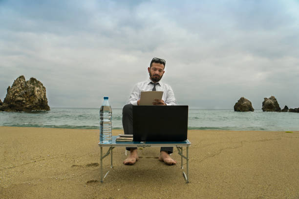 istock Businessman on the Beach - Work Follow 879781532