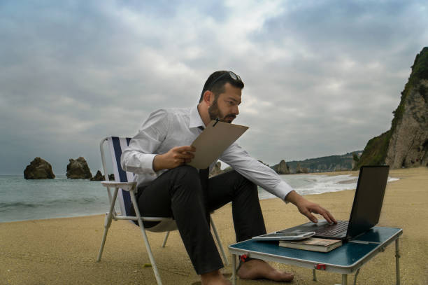 istock Businessman on the Beach - Work Follow 879781544