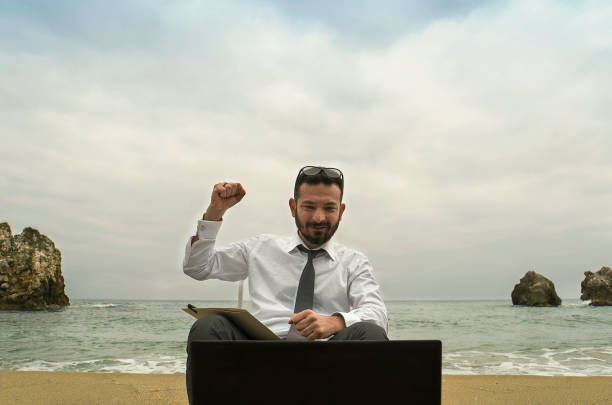 istock Businessman on the Beach - Work Follow 879781548