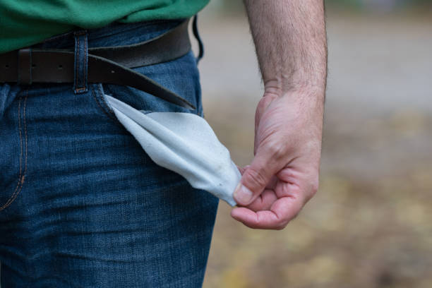 istock Man in jeans showing his empty pockets 879784946
