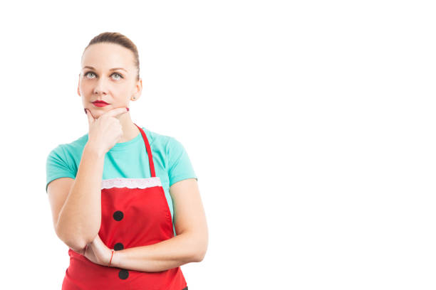 istock Woman wearing red Christmas apron thinking 879806486