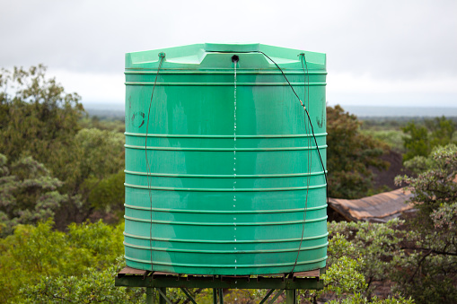 A plastic tank that collects rain water and when full it has an overflow value for the excess water stored.