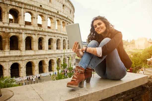 istock Smiling woman in front of Colosseum 879809486