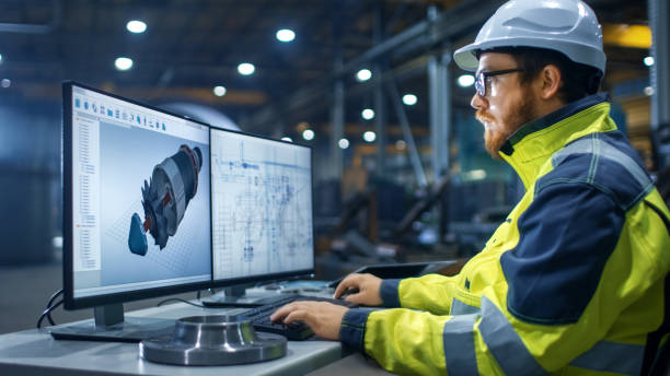 istock Inside the Heavy Industry Factory Industrial Engineer Works on the Personal Computer Designing Turbine/ Engine in 3D, Using CAD Program. 879814166