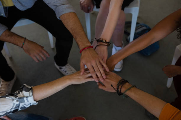 istock High angle view of adult students stacking hands 879814190