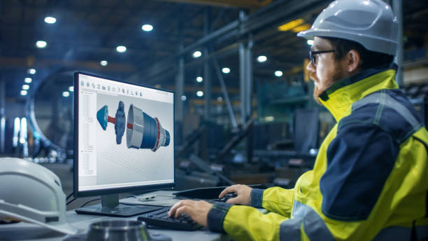 istock Inside the Heavy Industry Factory Industrial Engineer Works on the Personal Computer Designing Turbine/ Engine in 3D, Using CAD Program. 879814200
