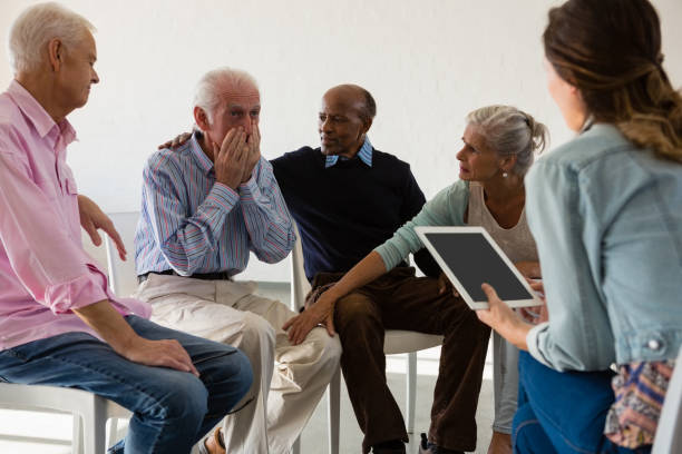istock Senior friends consoling man during discussion 879818966