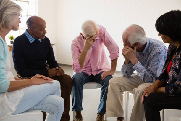 istock Senior friends looking at man with head in hand 879819358