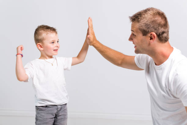 istock Handsome man with his son on white background 879825126