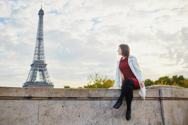 istock Young woman in Paris on a bright fall day 879825352