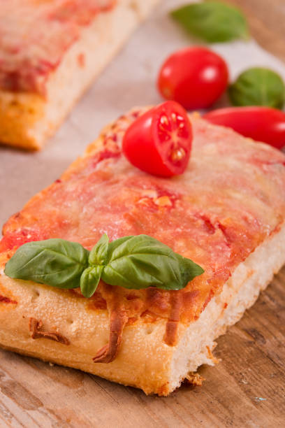 istock Italian pizza with cheese, tomatoes and fresh basil. 879828006