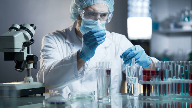 istock Laboratory worker measuring exact formula for hypoallergenic cosmetic products 879828756