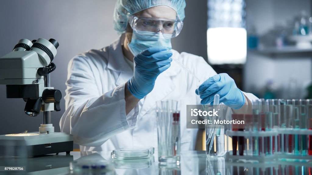 Laboratory worker measuring exact formula for hypoallergenic cosmetic products Oncology Stock Photo