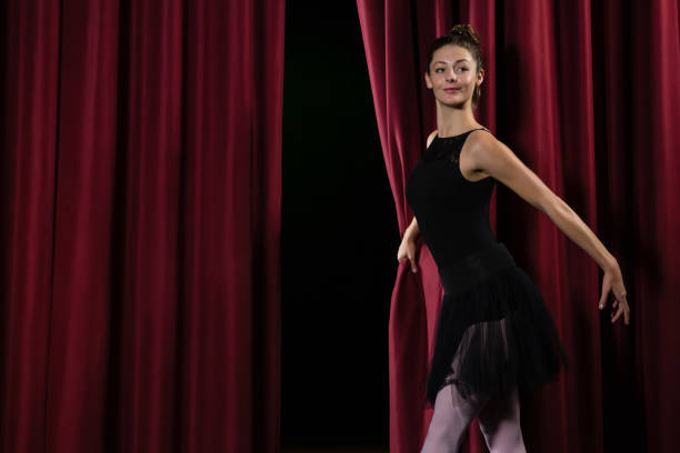 istock Ballerina performing ballet dance on stage 879834642