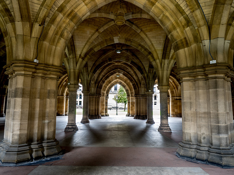 Glasgow, UK - July 20, 2017: the Cloisters connecting the quadrangles of the University of Glasgow in Glasgow, Scotland.  The medieval looking cloisters are featured in popular tv and movies series.