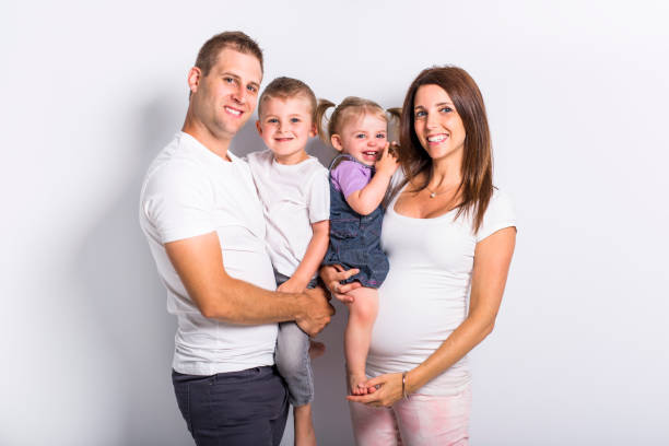 A Happy family with two kids on studio white