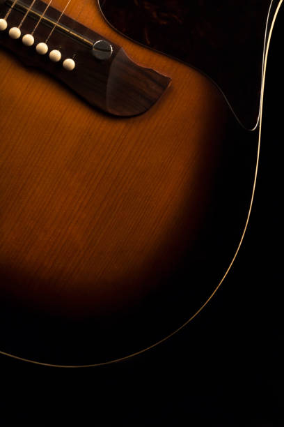 istock Acustic guitar on black background 879837380