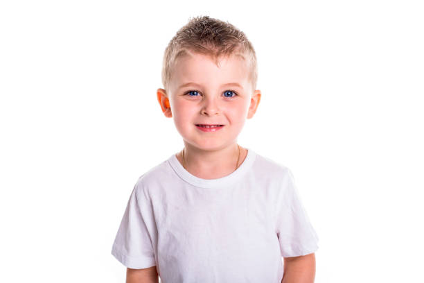 A Happy five year old European boy posing over white studio background. Child with big smile.