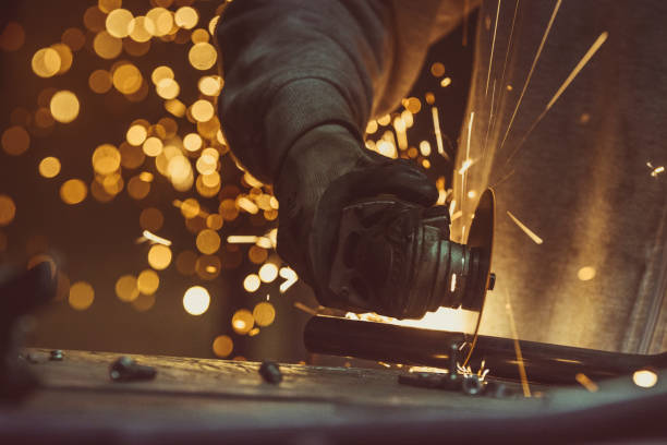 istock Creative and colored, horizontal image of man working with steel pipe, producing golden sparks on the work surface. 879844574