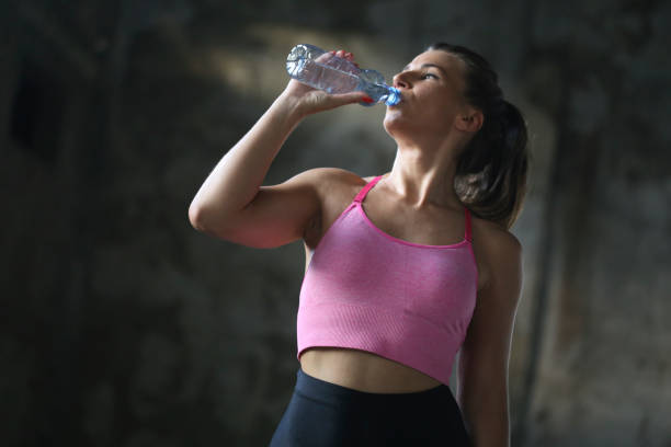 istock Beautiful woman drinking water 879860046