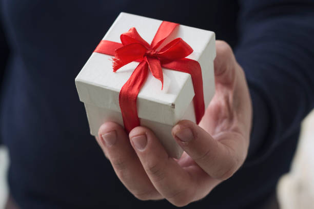 istock A man holding a gift box in his hands 879863348