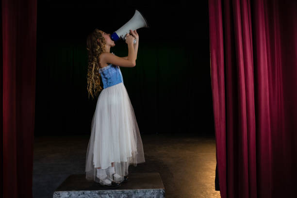 istock Female artist announcing on megaphone 879878758