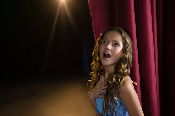 istock Female artist singing song on stage 879878922
