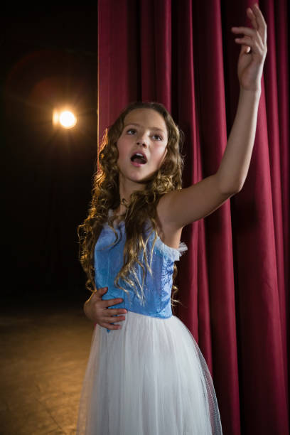 istock Female artist singing song on stage 879878954