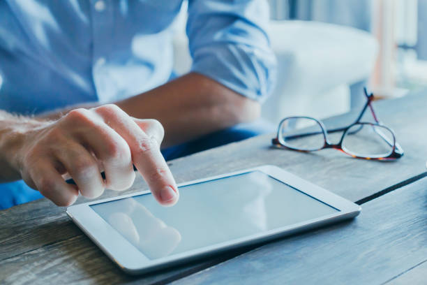 istock man reading emails and news on social media 879879042
