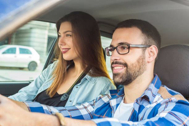 istock Young couple driving in car 879879120