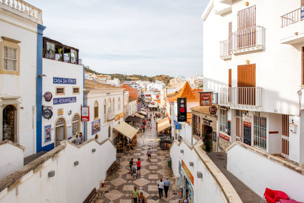 ALBUFEIRA, PORTUGAL - October 01, 2017: Cityscape view on the old town with crowded street with tourists on the south of Portugal