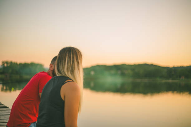 istock Young couple sitting on the dock 879908158