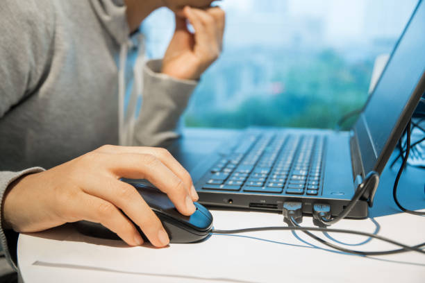 istock Closeup photo of female hands clicking mouse computer. 879912930