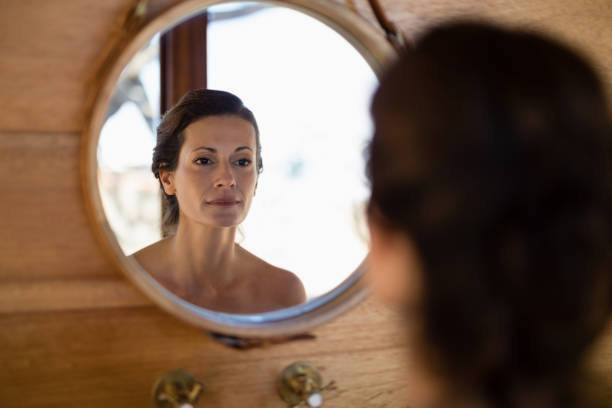 istock Woman looking at mirror in cottage 879916126