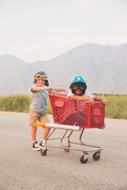 istock Young Boy Shopping Cart Racing Team 879916506