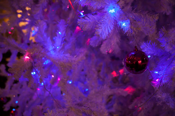 istock Red bauble hang on White Christmas trees are decorated with beautiful object 879916914