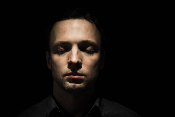 istock Face portrait of young man with closed eyes 879928254