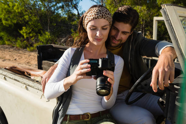 istock Young couple looking in camera at forest 879930908