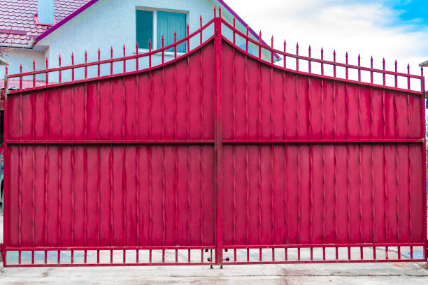 istock Steel rusty gates and a red brick fence 879931466