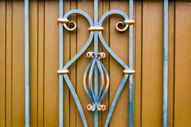 istock magnificent wrought-iron gates, ornamental forging, forged elements close-up 879931494