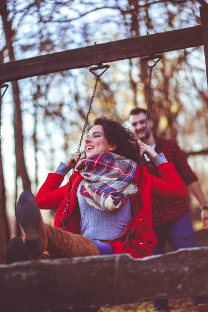 istock Romantic couple swing in the autumn park 879934204