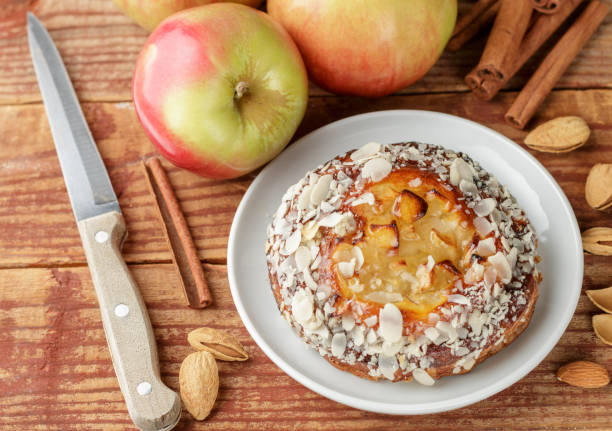 istock Homemade Apple pie with almonds and cinnamon. Dessert for tea in a rustic style. Selective focus. Top view 879940224
