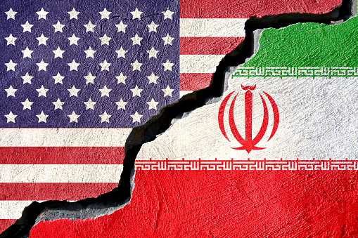 Concept american and Iran flag on cracked background
