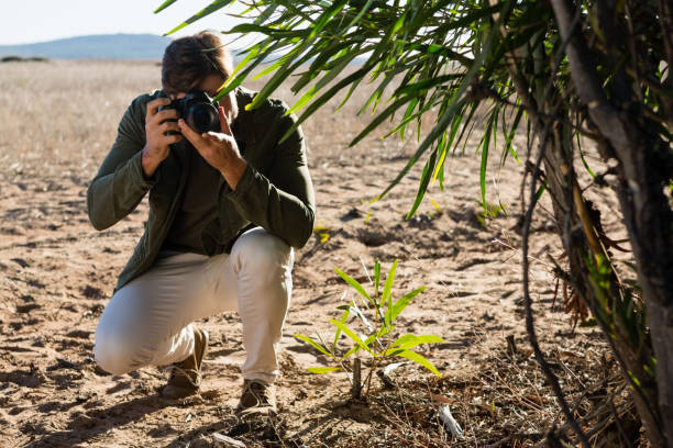 istock Man photographing on landscape 879946802