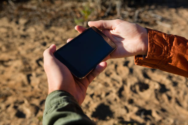 istock Cropped hands of couple using phone 879946930